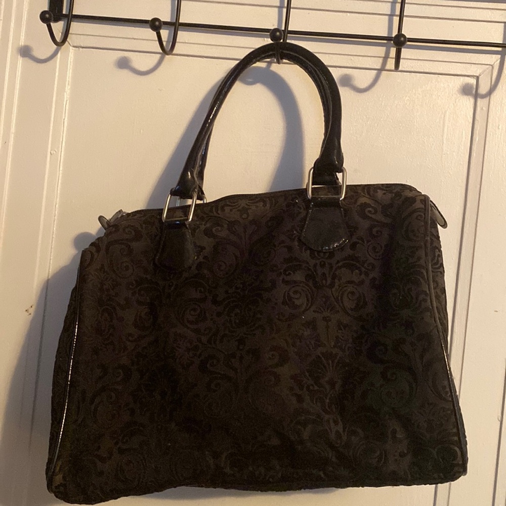 Black tapestry bag with velvet. Handles and trim are patent leather.